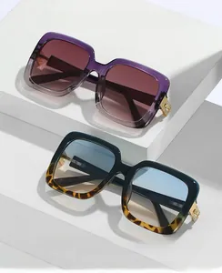 Close-up of oversized square sunglasses with gradient frames and diamond V-hinge detail