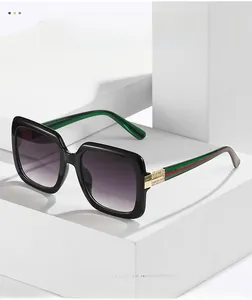 Detail of square black sunglasses with purple gradient lenses and rhinestone striped temples