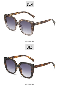 Close-up of square oversized sunglasses with marble and tortoiseshell patterns and gradient lenses