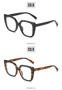Detail view of large square glasses in glossy black and tortoiseshell color options