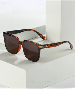 Detailed view of tortoiseshell oversized sunglasses frame with brown lenses and metal accents