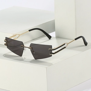 Modern rimless cat eye sunglasses with grey geometric lenses and gold hollow metal temples