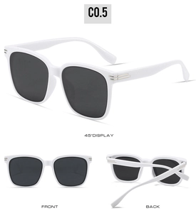 Detail view of large white square frame sunglasses with dark lenses and metallic accents