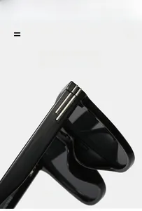 Detail of glossy black sunglasses frame with silver metal accents and flexible temples