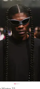 Close-up of futuristic silver wrap-around sports sunglasses with dark lenses