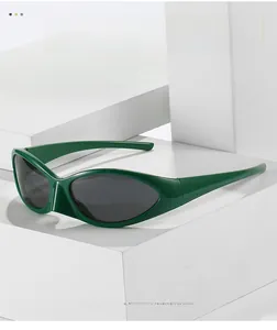 Detail view of modern green sports sunglasses on a white minimalist geometric block