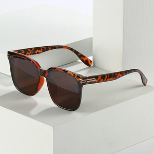 Oversize leopard print sunglasses with brown lenses and UV400 protection on white blocks