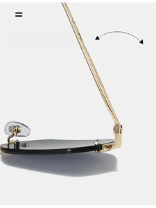 Macro detail of golden textured hinges and black lenses on rimless sunglasses