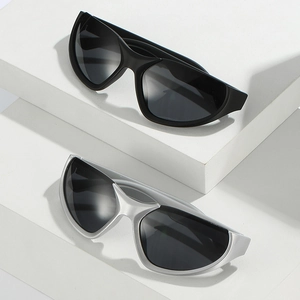 Futuristic streamlined sports sunglasses in black and silver finishes on geometric display