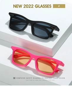 Close-up of stylish sports sunglasses in black and bright pink on geometric stands