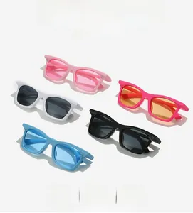 Flat lay of multiple colorful square fashion sunglasses with thick acetate frames and lenses
