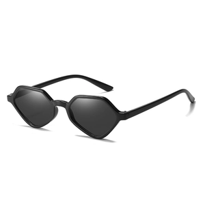 Minimalist geometric cat-eye sunglasses with thick black frames and dark tinted lenses