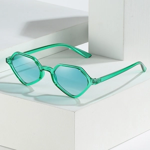 Green translucent geometric sunglasses with light blue lenses on a white pedestal