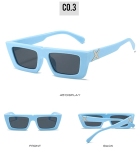 Detail view of retro blue square sunglasses with metal X-shaped temple decoration