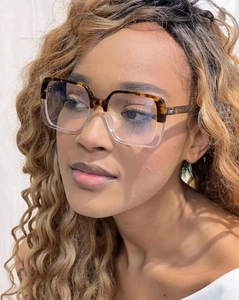 Detail of square oversized glasses with tortoiseshell and transparent frame on model