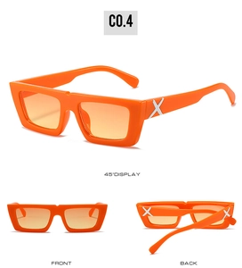 Detailed view of orange square sunglasses with silver X-shaped metal decor on temples