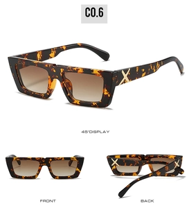 Detail of leopard print sunglasses with brown gradient lenses and gold X hinge decoration