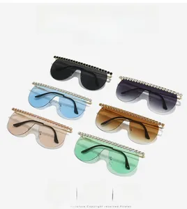 Macro shot of six oversized rimless sunglasses featuring crystal rhinestone-embellished top edges