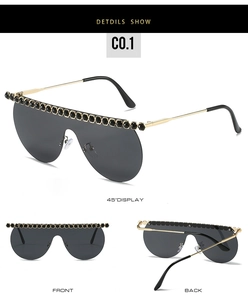 Detailed views of oversized sunglasses with black rhinestones and gold metal temples