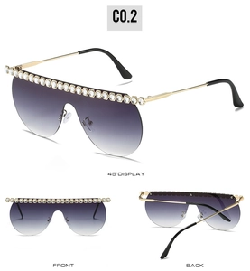 Detail of oversized sun shades with purple gradient lenses and sparkling rhinestones