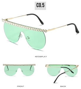 Mint green oversized shield sunglasses featuring crystal-encrusted frames and gold temples