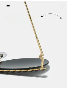 Detail of durable gold metal hinge and dark grey rhinestone studs on oversized sunglasses