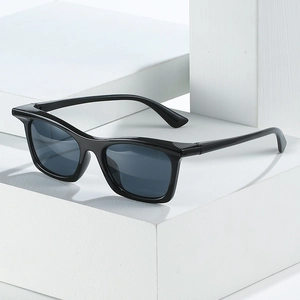 Classic black rectangular sunglasses with dark lenses on minimalist white cubes