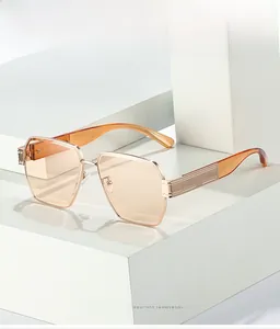 Detailed macro view of gold metal hinges and amber temples on square sunglasses