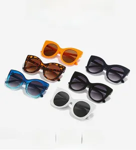 Flat lay of cat eye sunglasses in various colors including tortoiseshell and orange