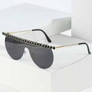 Oversized wrap-around sunglasses with black gems on gold frames for women