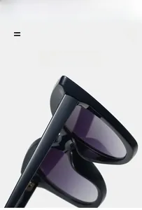 Detail of black frame cat eye sunglasses showing the lightweight and elastic hinge
