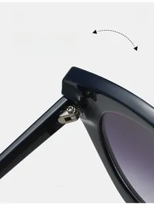 Detail of durable metal hinges on oversized cat-eye sunglasses with gradient purple lenses