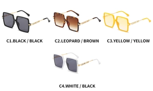 Detail of square oversized sunglasses with gold metal temples and LOVE ME engraving