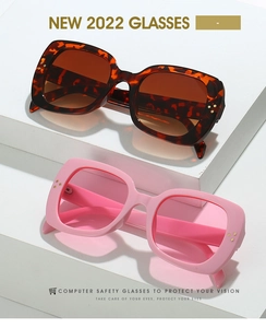 Close-up of vintage square sunglasses in tortoiseshell and soft pink frames with studs