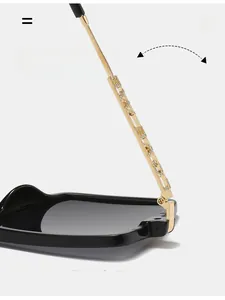 Macro detail of gold chain temple hinge with crystals on rimless sunglasses