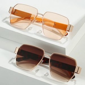Chic oversized geometric sunglasses with gold metal frames and gradient lenses