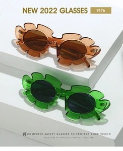Detail of sunflower petal-shaped resin sunglasses with tinted lenses on geometric stairs