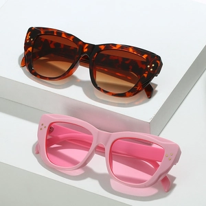 Fashionable cat eye sunglasses in tortoiseshell and pink frames with golden rivet accents