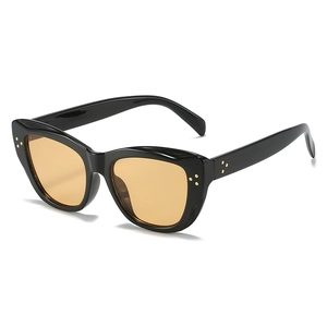 Retro cat-eye sunglasses with black frame, orange lenses and gold rivet accents