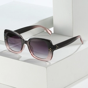 Stylish square oversized sunglasses with black pink gradient frames and gold rivet accents