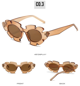 Detail view of flower-shaped sunglasses with translucent amber petal frames and matching lenses