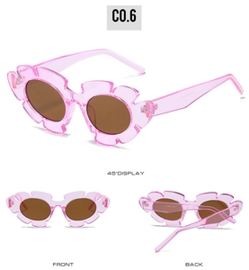 Three-way view of pink flower-shaped sunglasses with brown lenses and clear frames