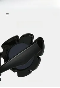 Macro detail of glossy black sunflower shaped sunglasses with flexible temples