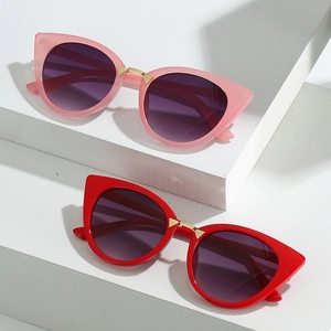 Chic cat eye sunglasses in red and pink with gold metal accents and gradient lenses