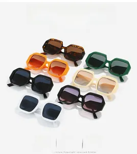 Detailed overhead display of stylish oversized hexagonal sunglasses in vibrant candy colors