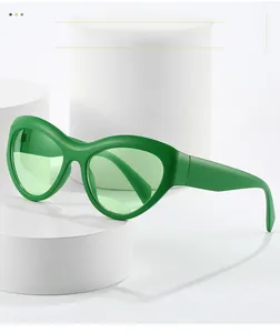 Détail de lunettes de soleil œil-de-chat vertes à monture épaisse sur support blanc