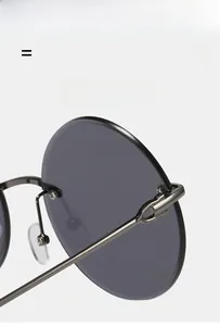 Detail shot of sturdy metal hinges and slim temples on oversized round sunglasses