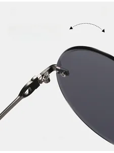 Detail of durable metal hinges on round rimless sunglasses with dark gray lenses
