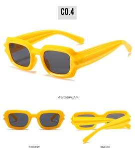 Detail view of bright yellow square cyberpunk sunglasses with rippled temples and dark lenses