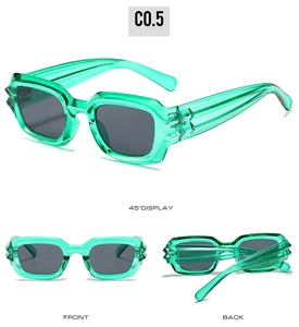 Detail of square green cyberpunk sunglasses with textured wavy arms and dark lenses